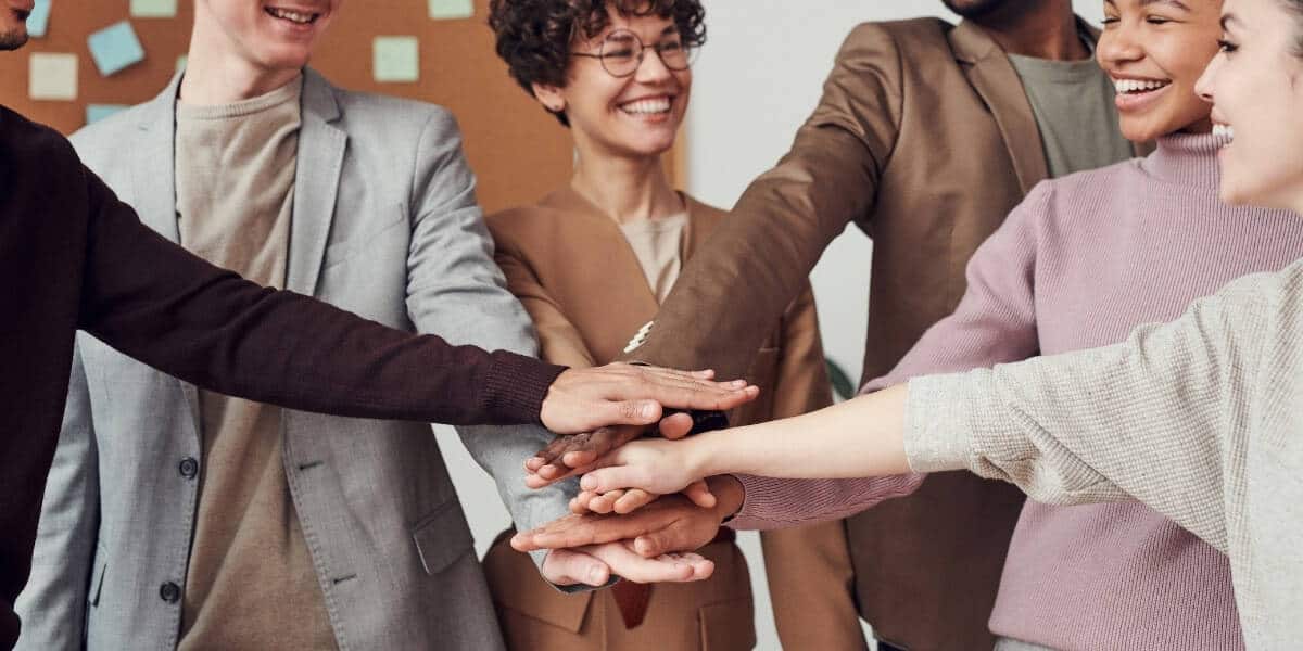 coworkers hands together in unison