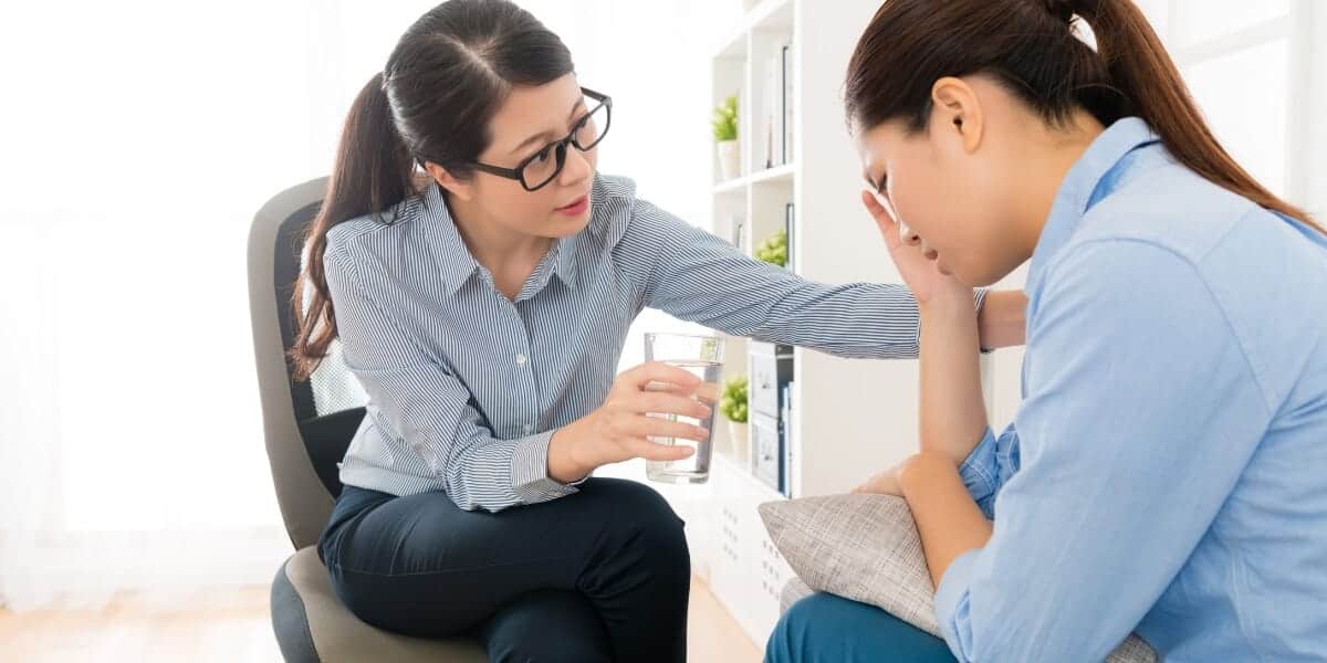 empathetic woman consoling another woman