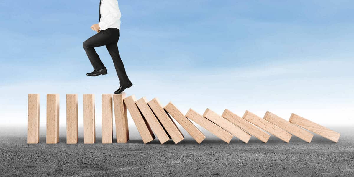 Man running on toppling blocks