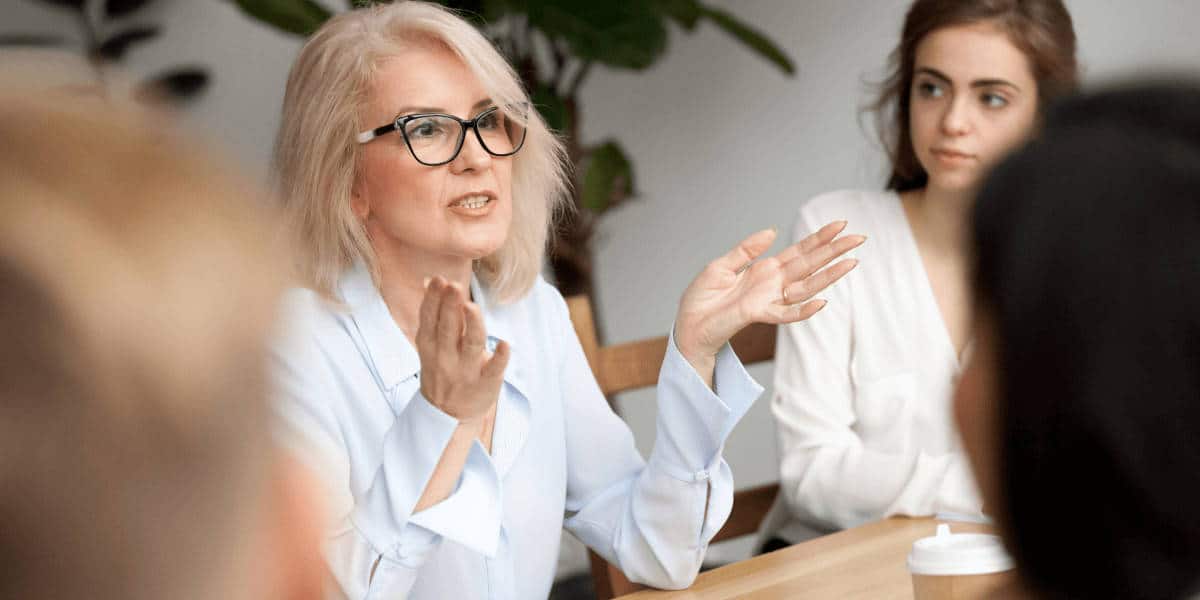 Woman speaking to employees