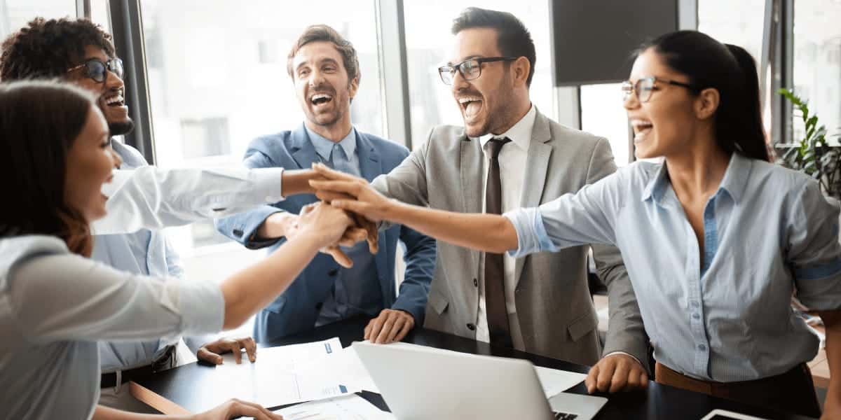 employess celebrating success with high fives