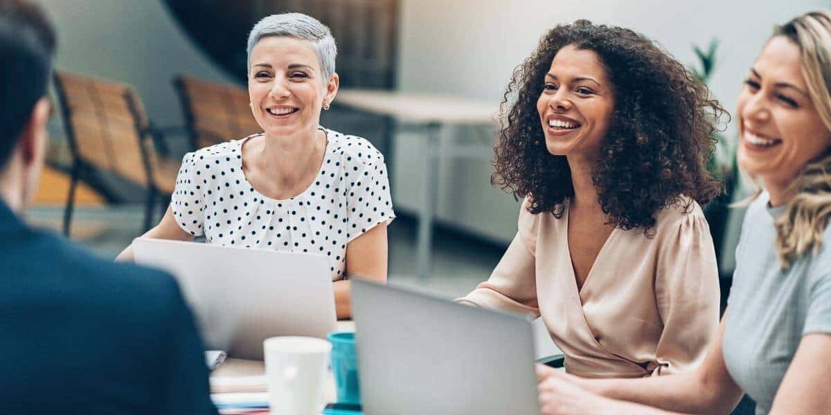 Happy employees sitting in meeting